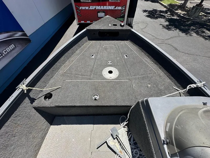 Slide: The Image of 2015 Lund 1625 Fury XL SS boat deck with storage compartments and ropes. - 18