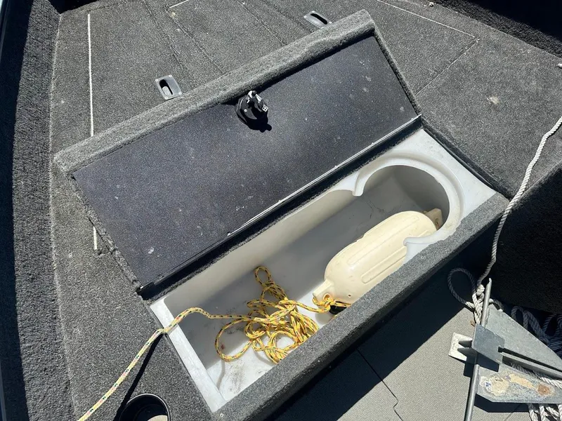 Slide: The Image of Open storage compartment in 2015 Lund 1625 Fury XL SS boat with rope and fender. - 19