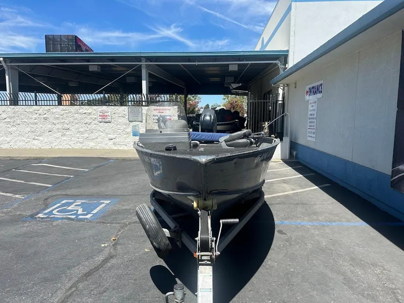 Slide: The Image of 2015 Lund 1625 Fury XL SS boat on trailer in parking lot. - 3