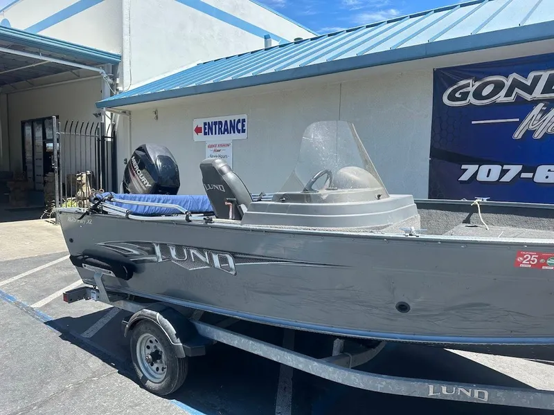 Slide: The Image of 2015 Lund 1625 Fury XL SS boat on trailer outside a building. - 6