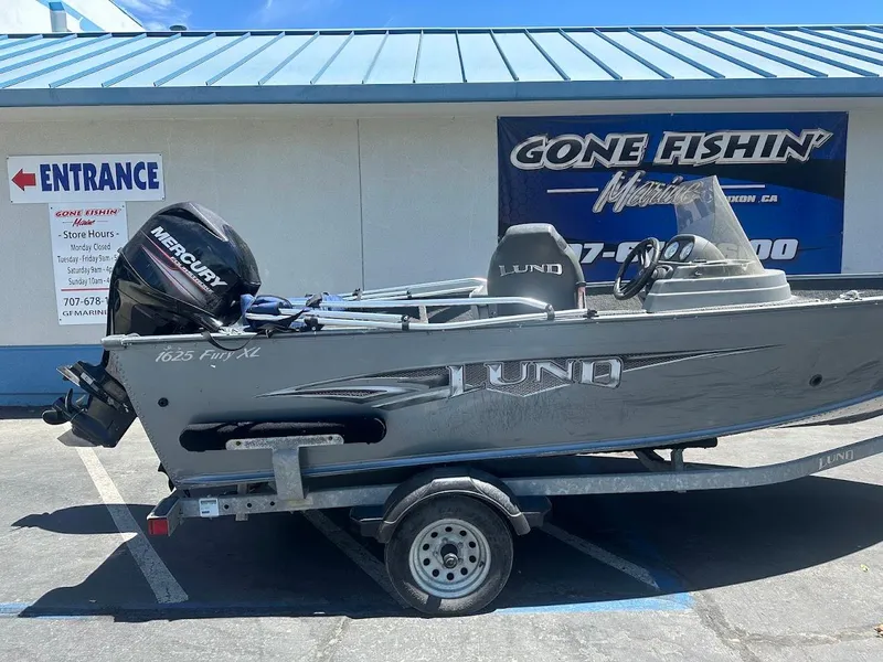 Slide: The Image of 2015 Lund 1625 Fury XL SS boat on trailer, parked outside Gone Fishin' Marine store. - 7