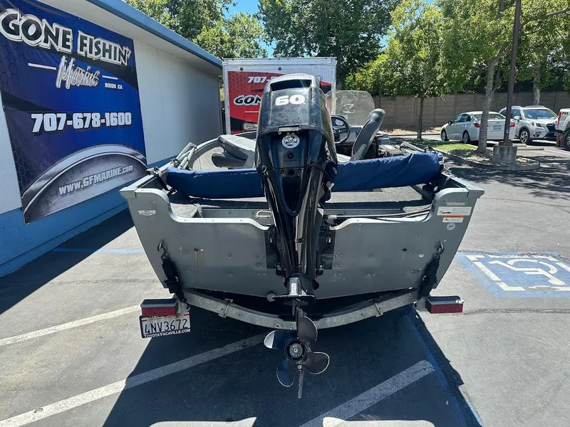 Slide: The Image of 2015 Lund 1625 Fury XL SS boat with outboard motor in parking lot. - 9