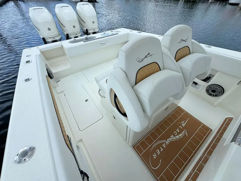 Slide: The Image of Luxurious 2021 Blackwater 36 Sport boat interior with white and tan seating on open water. - 10