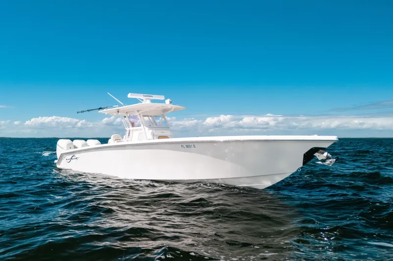 Slide: The Image of 2021 Blackwater 36 Sport boat cruising on open ocean under clear blue sky. - 17