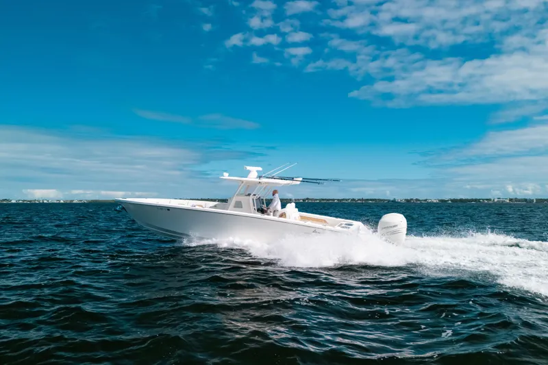 Slide: The Image of 2021 Blackwater 36 Sport boat cruising on open water under a clear blue sky. - 19