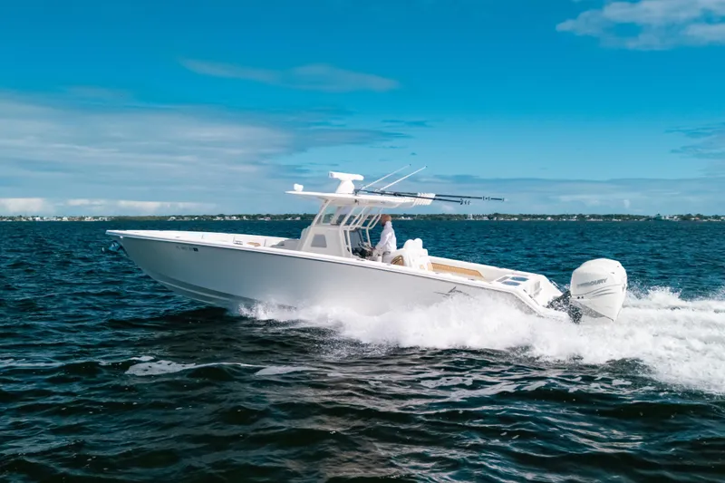 Slide: The Image of 2021 Blackwater 36 Sport boat cruising on open water under a clear blue sky. - 20
