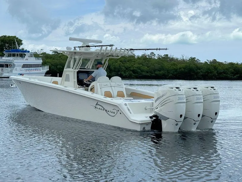 Slide: The Image of 2021 Blackwater 36 Sport boat cruising on open blue water under clear sky. - 5