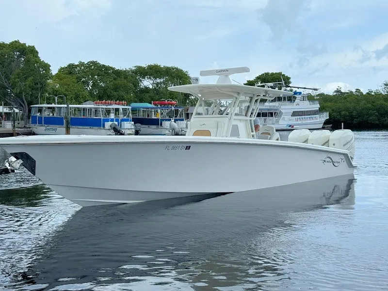 Slide: The Image of 2021 Blackwater 36 Sport boat cruising on open water under clear blue skies. - 8