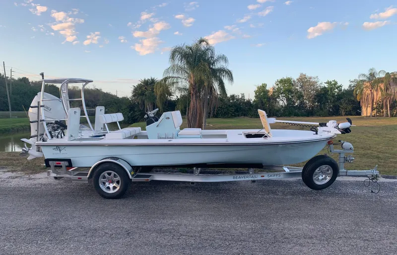 Slide: The Image of 2022 Beavertail Skiffs Vengeance boat on trailer, parked outdoors under a blue sky. - 0