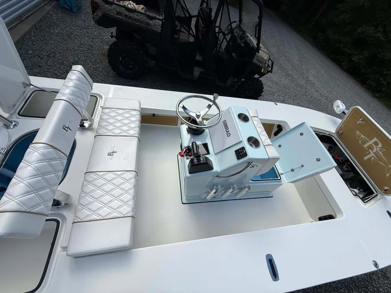 Slide: The Image of 2022 Beavertail Skiffs Vengeance interior with white seating and steering console. - 10
