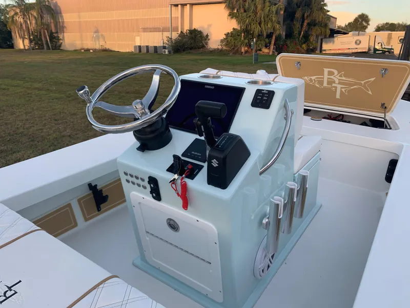Slide: The Image of 2022 Beavertail Skiffs Vengeance boat console with steering wheel and controls. - 12