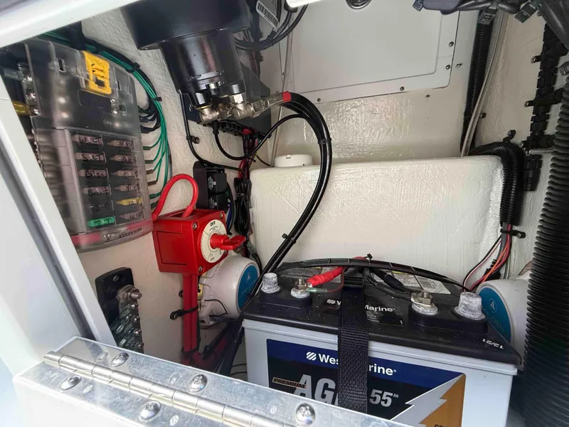 Slide: The Image of 2022 Beavertail Skiffs Vengeance electrical compartment with battery and wiring components. - 14