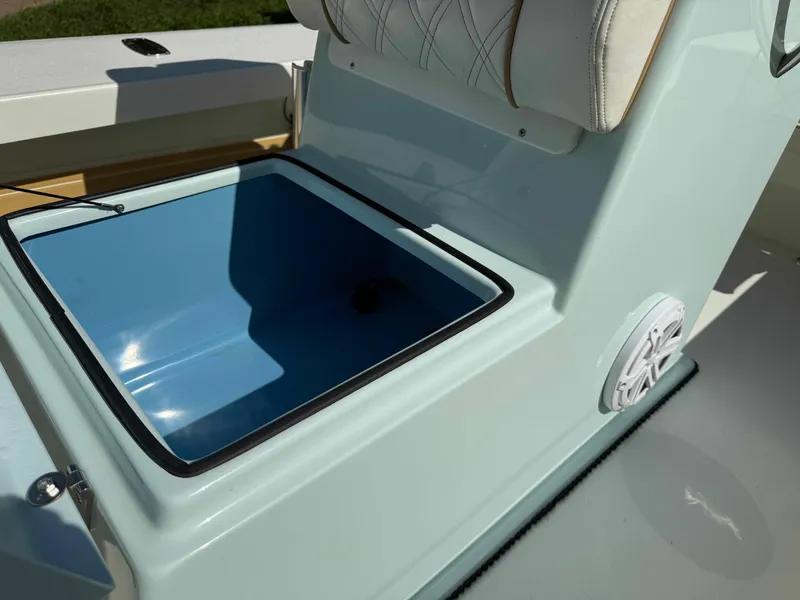Slide: The Image of 2022 Beavertail Skiffs Vengeance boat storage compartment with cushioned seat and speaker. - 15