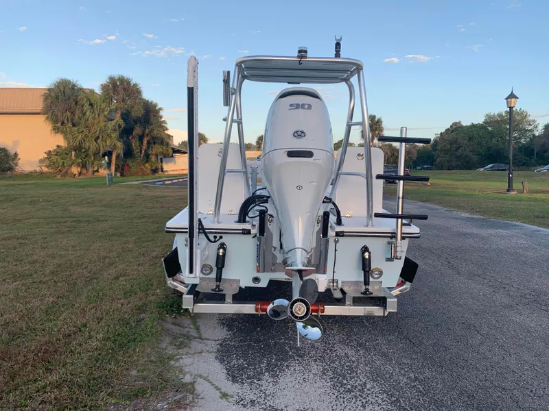 Slide: The Image of 2022 Beavertail Skiffs Vengeance boat with 90 HP engine, parked on a paved road. - 2