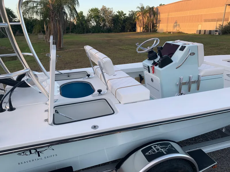 Slide: The Image of 2022 Beavertail Skiffs Vengeance boat with sleek design and modern console, parked outdoors. - 20