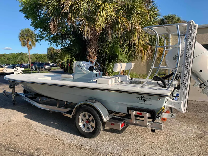 Slide: The Image of 2022 Beavertail Skiffs Vengeance boat on trailer, parked near palm trees. - 5