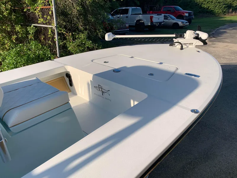 Slide: The Image of 2022 Beavertail Skiffs Vengeance boat with Minn Kota trolling motor, parked outdoors. - 6