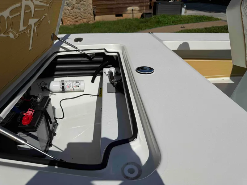 Slide: The Image of 2022 Beavertail Skiffs Vengeance boat compartment with battery and fire extinguisher. - 9