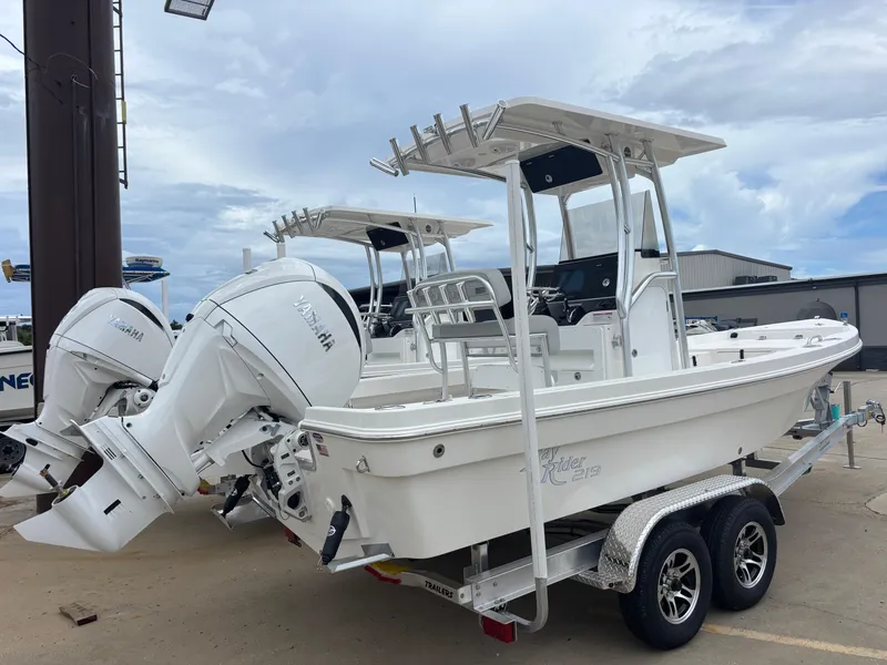 Slide: The Image of 2026 Bay Rider 219 Bay boat with dual Yamaha engines on a trailer. - 2