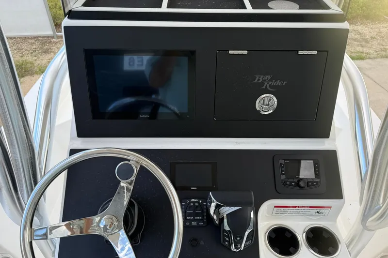Slide: The Image of 2026 Bay Rider 219 Bay boat dashboard with steering wheel and control panel. - 25