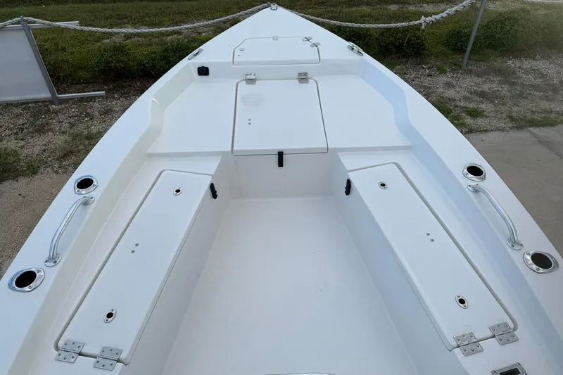 Slide: The Image of 2026 Bay Rider 219 Bay boat interior with storage compartments and rod holders. - 26