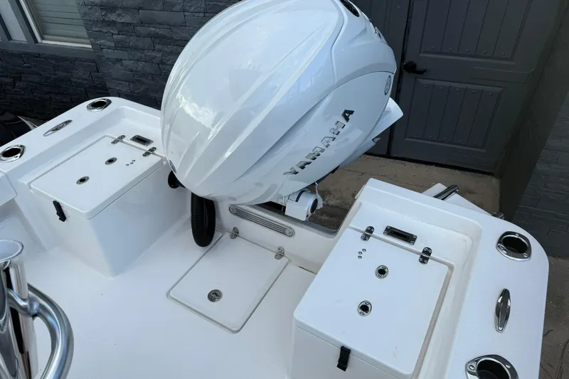 Slide: The Image of 2026 Bay Rider 219 Bay boat with Yamaha outboard motor, featuring storage compartments. - 29