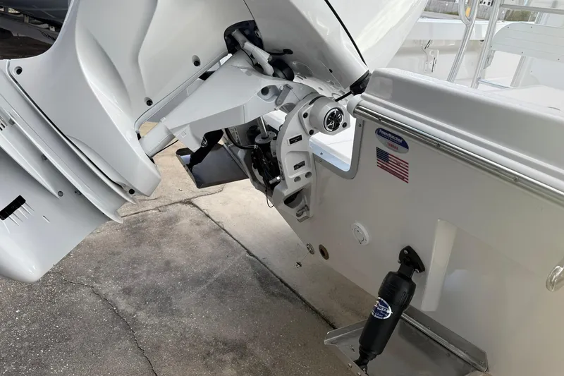 Slide: The Image of 2026 Bay Rider 219 Bay boat engine and transom detail with American flag sticker. - 32
