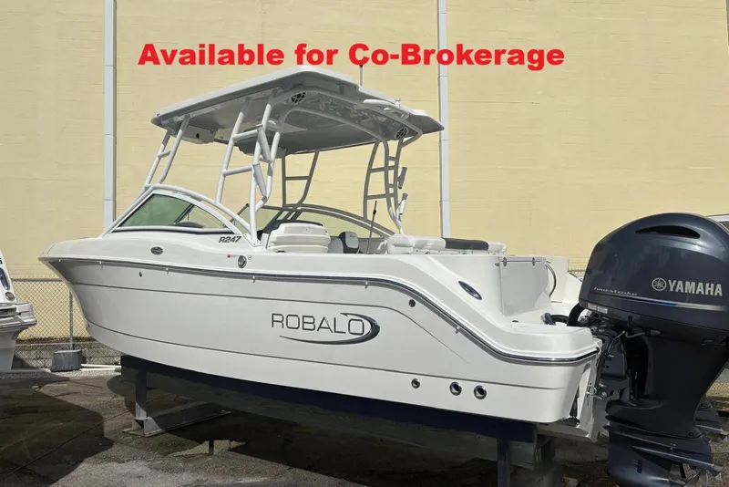 The Image of 2021 Robalo R247 Dual Console boat with twin Yamaha 200 engines, docked outdoors. - 0