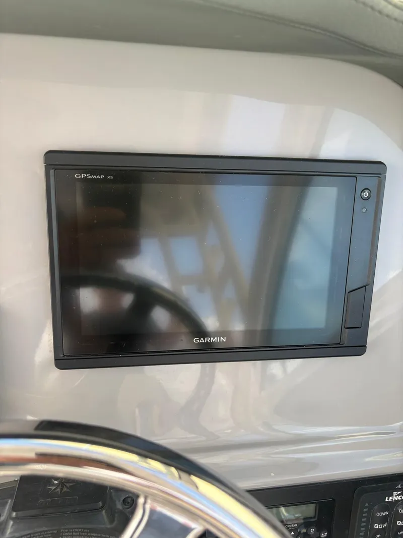 Slide: The Image of 2021 Robalo R247 Dual Console boat dashboard with controls and steering wheel. - 10