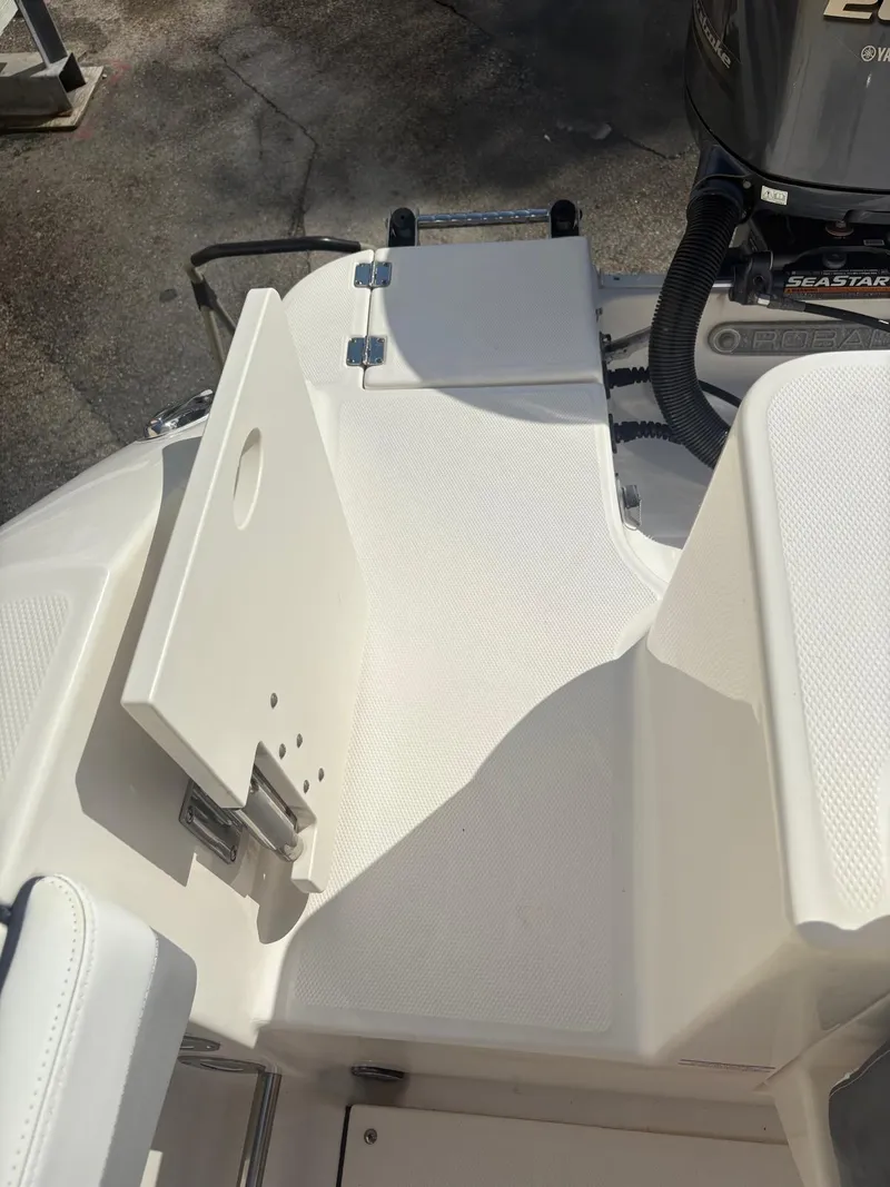 Slide: The Image of 2021 Robalo R247 Dual Console boat interior with steering wheel and seating. - 16