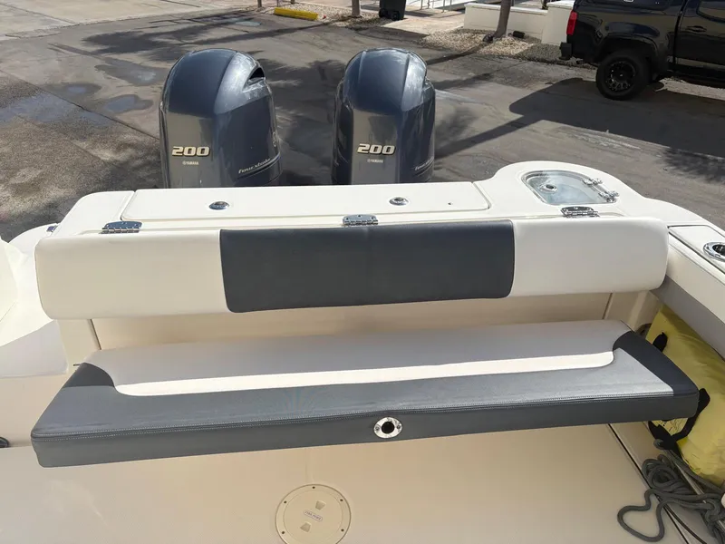 Slide: The Image of 2021 Robalo R247 Dual Console with twin Yamaha 200 engines, parked on a sunny day. - 18