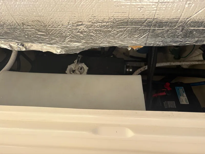 Slide: The Image of 2021 Robalo R247 Dual Console interior with seating and cooler. - 21