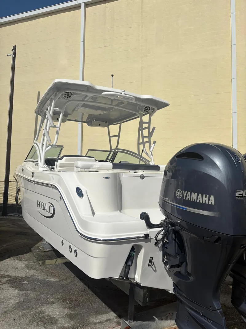 Slide: The Image of 2021 Robalo R247 Dual Console boat with Yamaha engine, displayed outdoors. - 28