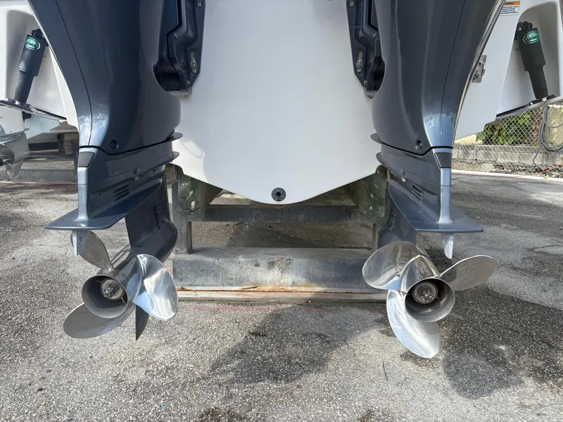 Slide: The Image of 2021 Robalo R247 Dual Console boat with dual outboard motors and propellers. - 29