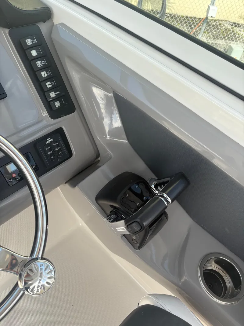 Slide: The Image of 2021 Robalo R247 Dual Console helm with Garmin display and steering wheel. - 9