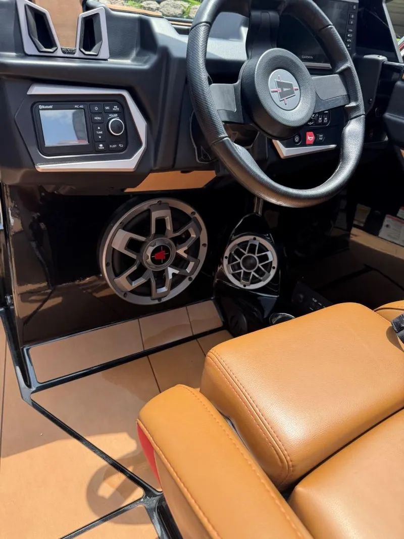 Slide: The Image of Interior of 2022 Axis T250 boat with steering wheel and audio system. - 19