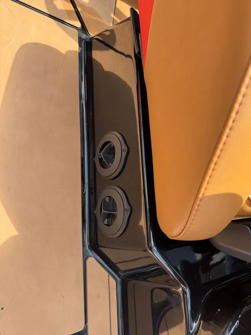 Slide: The Image of Close-up of Axis T250 2022 boat interior with tan seating and black cup holders. - 20