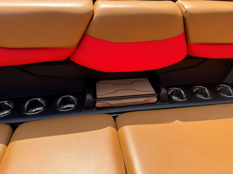 Slide: The Image of 2022 Axis T250 boat interior with tan and red seating, featuring multiple cup holders. - 24