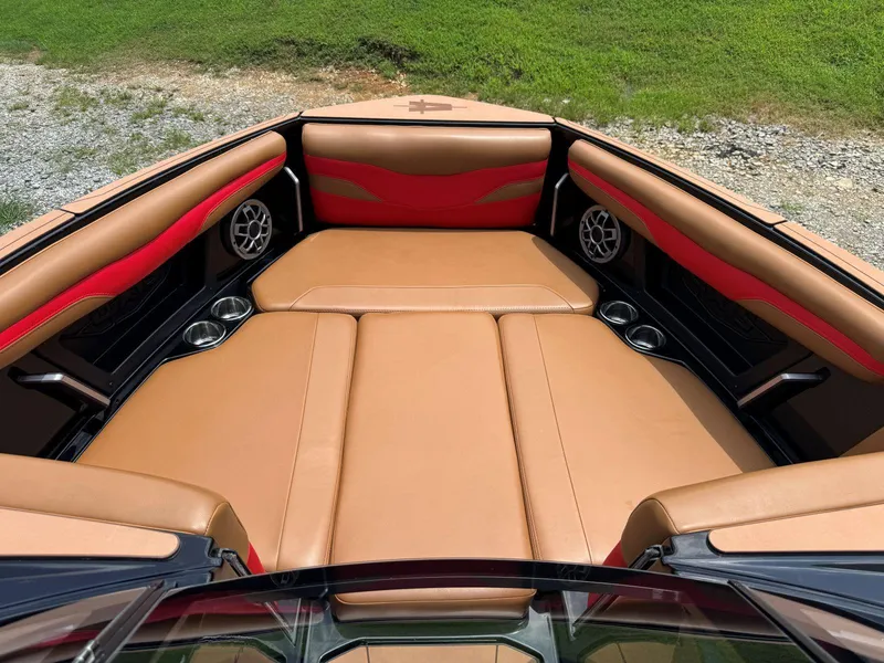 Slide: The Image of 2022 Axis T250 boat interior with tan and red seating, cup holders, and speakers. - 27