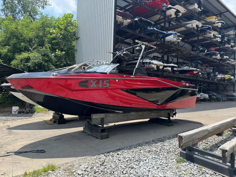 Slide: The Image of 2022 Axis T250 boat in storage, vibrant red color, outdoor setting. - 3