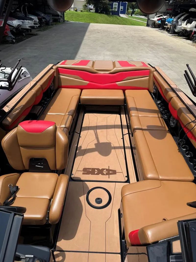 Slide: The Image of 2022 Axis T250 boat interior with tan and red seating, spacious layout. - 31