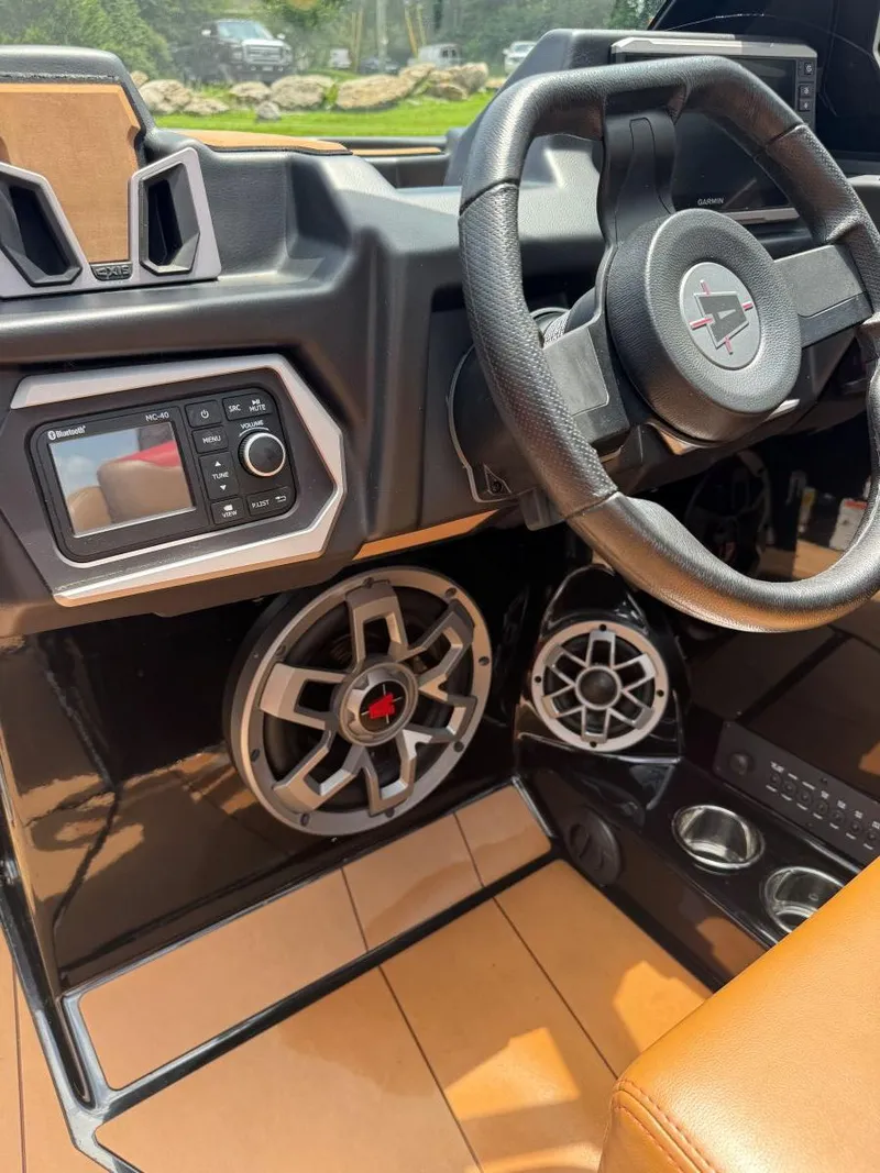 Slide: The Image of 2022 Axis T250 boat dashboard with steering wheel, audio controls, and speakers. - 40