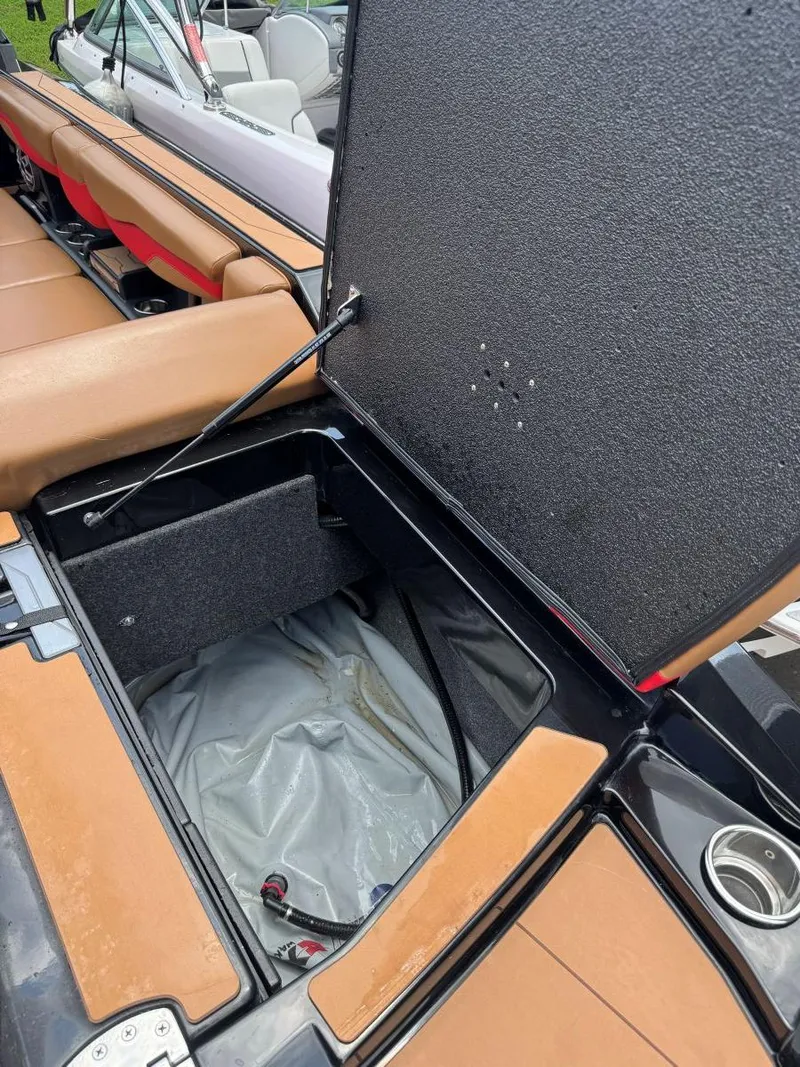 Slide: The Image of Open storage compartment in 2022 Axis T250 boat with tan seating. - 42
