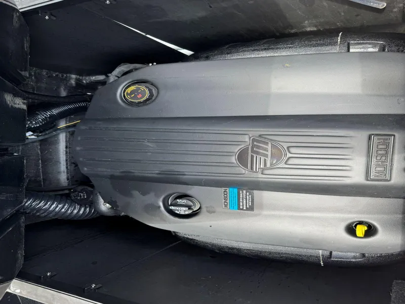 Slide: The Image of 2022 Axis T250 engine compartment with Monsoon cover, showcasing mechanical components. - 43