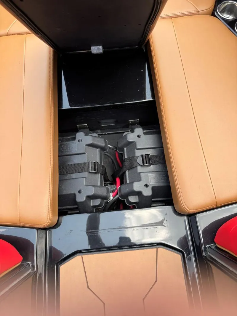 Slide: The Image of 2022 Axis T250 boat interior with storage compartment and batteries. - 47