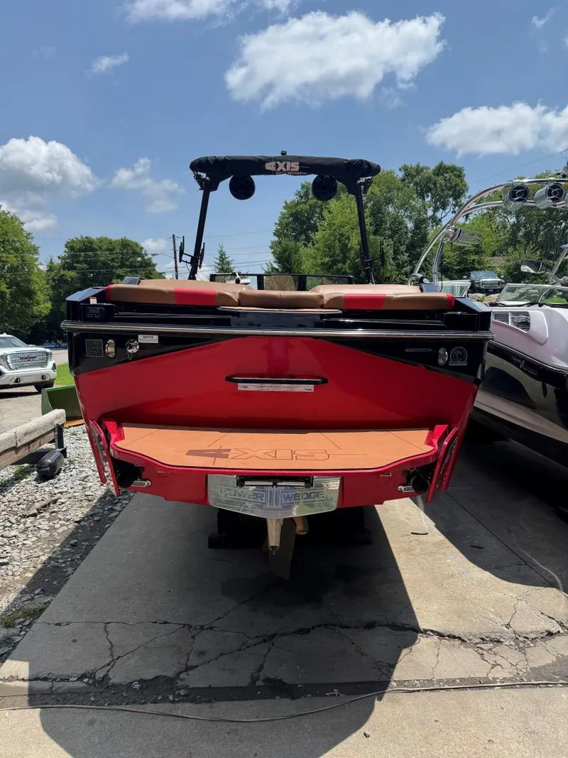 Slide: The Image of Red 2022 Axis T250 boat parked on concrete under a blue sky. - 8