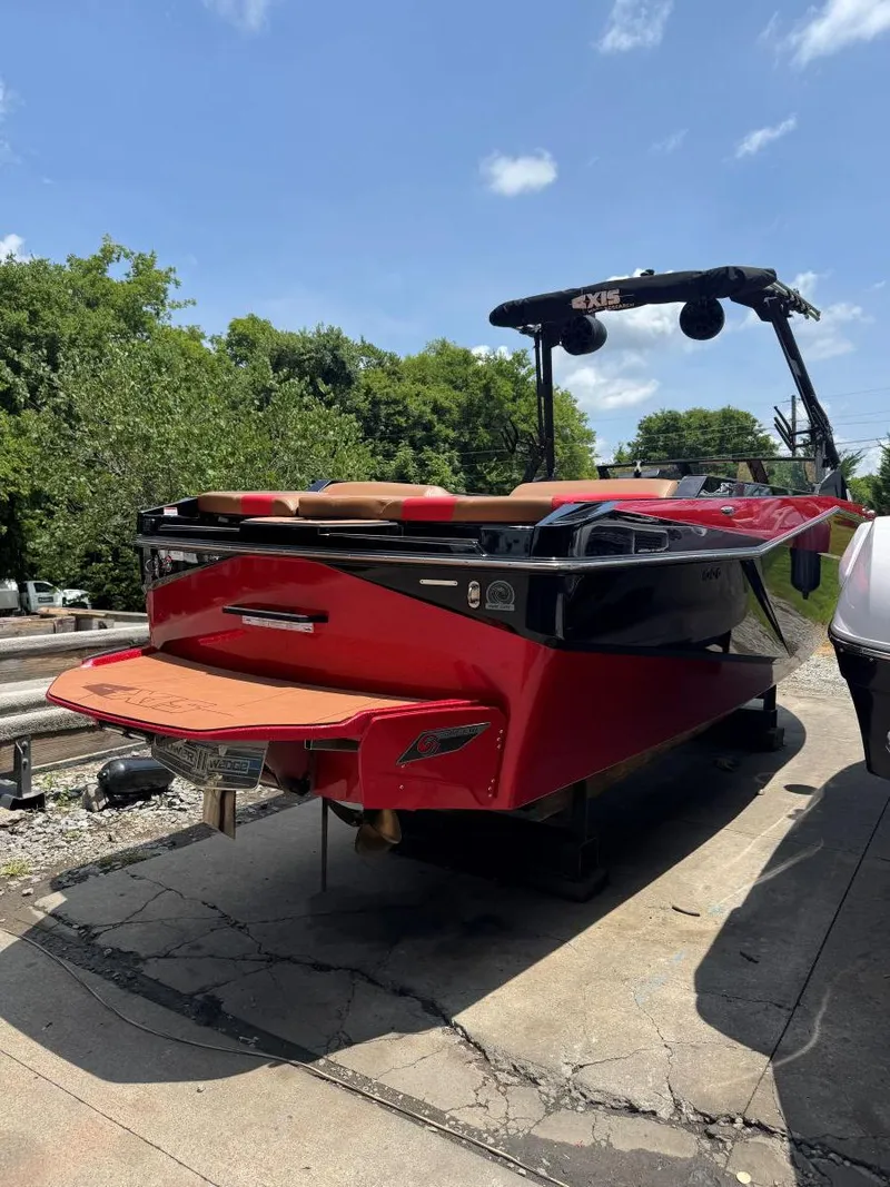 Slide: The Image of Red 2022 Axis T250 boat parked outdoors on a sunny day. - 9