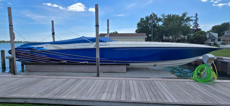 Slide: The Image of 2007 Fountain 42 Executioner speedboat docked, featuring sleek blue and white design. - 1