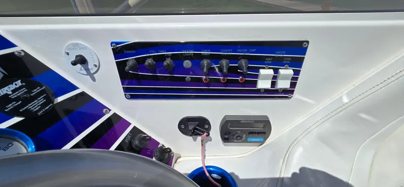 Slide: The Image of Control panel of a 2007 Fountain 42 Executioner boat with switches and audio system. - 12