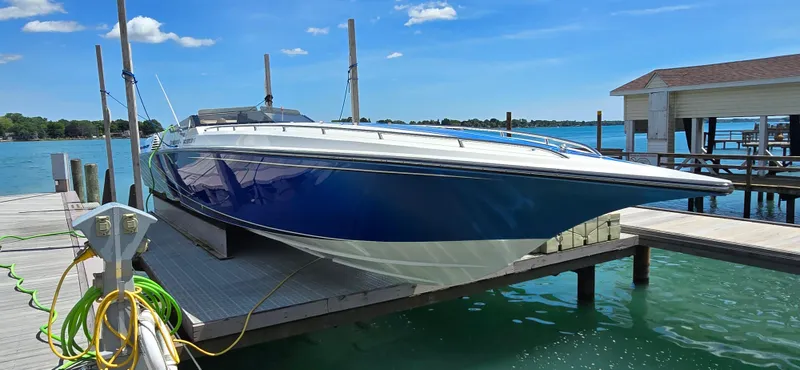 Slide: The Image of 2007 Fountain 42 Executioner speedboat docked on a sunny day by the lake. - 2